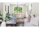 Bright dining area with wood floors, white table, natural light, and views to the yard at 5001 Simpson Dr, Sanford, NC 27330