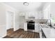 Well-designed kitchen with stainless steel appliances, bright white cabinets, and modern countertops at 5001 Simpson Dr, Sanford, NC 27330
