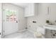 Bright laundry room with tile floor, a door to the exterior, and sink at 5001 Simpson Dr, Sanford, NC 27330
