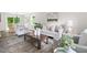 Spacious living room with wood floors, neutral furniture, and view of the backyard at 5001 Simpson Dr, Sanford, NC 27330