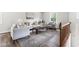 Bright living room with natural light, wood floors, neutral furniture, and stylish rug at 5001 Simpson Dr, Sanford, NC 27330