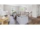 Living room features light gray walls, wood floors, staircase, and neutral furniture at 5001 Simpson Dr, Sanford, NC 27330