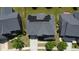 An aerial view of a home featuring solar panels on the roof, a driveway, and manicured landscaping at 5016 Trembath Ln, Cary, NC 27519