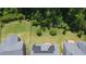 Aerial view showcasing a home with solar panels, surrounded by lush greenery and neighboring yards at 5016 Trembath Ln, Cary, NC 27519
