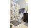 Traditional bathroom with tile flooring, vanity and a shower with a decorative curtain at 5016 Trembath Ln, Cary, NC 27519