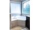 Bright bathroom featuring a corner tub with tile surround, granite countertop, and bright window at 5016 Trembath Ln, Cary, NC 27519