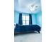 Bedroom with carpeted floors, a window with blue curtains, a ceiling fan, and blue walls at 5016 Trembath Ln, Cary, NC 27519