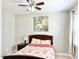 Cozy bedroom with a ceiling fan, carpet floors, natural light, and a warm ambiance at 5016 Trembath Ln, Cary, NC 27519