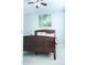 This primary bedroom includes a ceiling fan and a decorative butterfly wall art at 5016 Trembath Ln, Cary, NC 27519