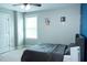 A cozy bedroom with gray carpet, gray walls and a single window with natural light at 5016 Trembath Ln, Cary, NC 27519