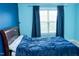 Bedroom with light blue walls, carpet, window with curtains, and dark wood queen bed at 5016 Trembath Ln, Cary, NC 27519