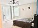 Bedroom featuring light gray walls, a ceiling fan, and a window creating a cozy and inviting space at 5016 Trembath Ln, Cary, NC 27519
