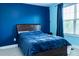 Bedroom with navy walls, carpeted floor, window with blue curtains, and queen size bed at 5016 Trembath Ln, Cary, NC 27519