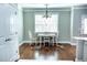 Bright breakfast nook features a window, chandelier, table, and chairs set atop a colorful rug at 5016 Trembath Ln, Cary, NC 27519