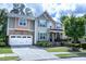 Beautiful home featuring stone accents, multi-colored siding and an attached two car garage at 5016 Trembath Ln, Cary, NC 27519