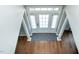 Elegant foyer features hardwood floors, white columns and a glass paneled front door at 5016 Trembath Ln, Cary, NC 27519