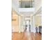 Grand foyer with hardwood floors, white columns, high ceilings, and an open staircase at 5016 Trembath Ln, Cary, NC 27519