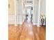 Inviting hallway with hardwood floors, decorative columns, and a view into other rooms at 5016 Trembath Ln, Cary, NC 27519