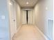 A carpeted hallway with white doors and light gray walls connects different areas of the home at 5016 Trembath Ln, Cary, NC 27519
