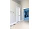 Hallway with tile floors and white doors leading to bedrooms and other rooms in the house at 5016 Trembath Ln, Cary, NC 27519