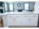 Modern kitchen with stainless steel appliances, white cabinets, and island seating at 5016 Trembath Ln, Cary, NC 27519