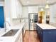 Open concept kitchen featuring stainless steel appliances, custom cabinetry, and hardwood floors at 5016 Trembath Ln, Cary, NC 27519
