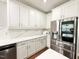 Modern kitchen featuring stainless steel appliances and beautiful white cabinetry at 5016 Trembath Ln, Cary, NC 27519