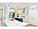 Spacious kitchen features a center island, stainless appliances, and bright, white cabinetry at 5016 Trembath Ln, Cary, NC 27519