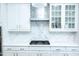 Bright kitchen featuring white cabinets, modern stainless steel appliances, and a beautiful marble backsplash at 5016 Trembath Ln, Cary, NC 27519