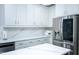 Modern kitchen with stainless steel appliances, white cabinets, a blue island, and ample counter space at 5016 Trembath Ln, Cary, NC 27519