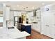 Modern kitchen with stainless steel appliances, a large island, and bright white cabinetry at 5016 Trembath Ln, Cary, NC 27519