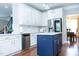 Modern kitchen with stainless steel appliances, white cabinets, a blue island, and ample counter space at 5016 Trembath Ln, Cary, NC 27519