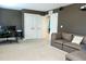 Finished basement with a gray couch, computer desk and a movie projector on the ceiling at 5016 Trembath Ln, Cary, NC 27519