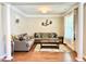 Comfortable living room featuring hardwood floors, large windows, and neutral decor at 5016 Trembath Ln, Cary, NC 27519
