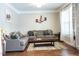 Cozy living room with hardwood floors, comfortable seating, and neutral color palette at 5016 Trembath Ln, Cary, NC 27519