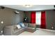 Finished basement with a gray couch, large window and a movie projector on the ceiling at 5016 Trembath Ln, Cary, NC 27519