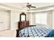 A main bedroom with a tray ceiling, a ceiling fan, and a dresser against a light gray wall offers ample space at 5016 Trembath Ln, Cary, NC 27519