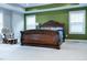 Spacious main bedroom with carpet flooring, and a rocking chair near two windows at 5016 Trembath Ln, Cary, NC 27519