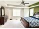 A spacious main bedroom with a tray ceiling, ceiling fan, and dresser provides ample natural light at 5016 Trembath Ln, Cary, NC 27519