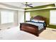 A spacious main bedroom with a tray ceiling, ceiling fan, and two windows providing ample natural light at 5016 Trembath Ln, Cary, NC 27519