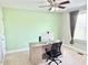 A carpeted room with a desk, office chair, and a window with neutral-colored curtains is ideal for a home office at 5016 Trembath Ln, Cary, NC 27519