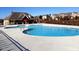 Community pool area with a lifeguard stand, surrounding lounge space, and neighborhood homes view at 5016 Trembath Ln, Cary, NC 27519