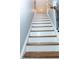 Staircase with wooden treads and black metal railing leads to the upper level at 5016 Trembath Ln, Cary, NC 27519