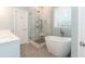 Modern bathroom with a soaking tub, glass-enclosed shower, and a sleek vanity at 5609 Barham Ct, Raleigh, NC 27613