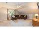 Upstairs bonus room with a comfortable sofa and natural light at 5609 Barham Ct, Raleigh, NC 27613