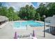 Large community swimming pool with lounge chairs and umbrellas at 5609 Barham Ct, Raleigh, NC 27613