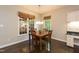 Cozy dining area with natural light, a wooden table set, and windows with woven shades at 5609 Barham Ct, Raleigh, NC 27613