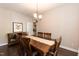 Formal dining room with hardwood floors, traditional lighting, and wooden furniture set at 5609 Barham Ct, Raleigh, NC 27613