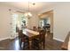 Formal dining room with hardwood floors, traditional lighting, and wooden furniture set at 5609 Barham Ct, Raleigh, NC 27613