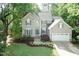 Charming two-story home with manicured lawn and attached two car garage offers curb appeal at 5609 Barham Ct, Raleigh, NC 27613